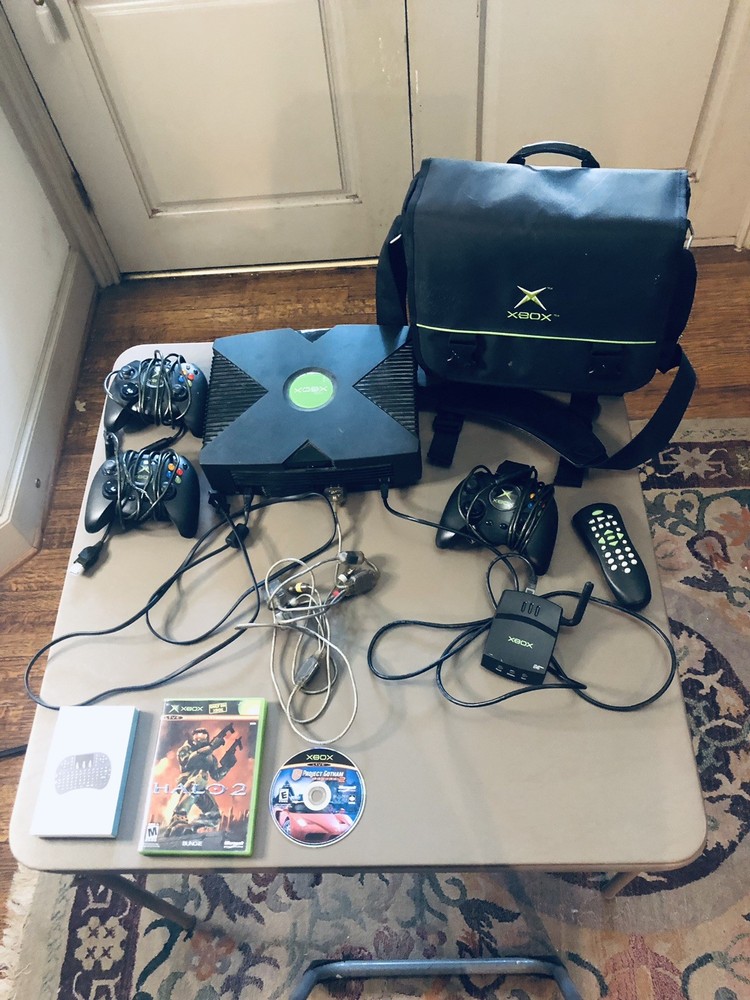 Xbox console, three controllers, carryting case, 2 games, and more
