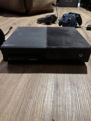 xbox one x black console with controllers and headset