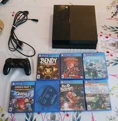 Sony PlayStation 4 500GB with cords, controller, and games