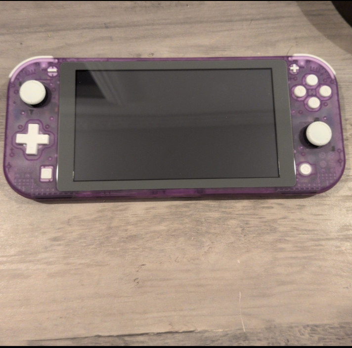 Nintendo Switch lite shell swapped with eXtremeRate clear atomic purple shell.