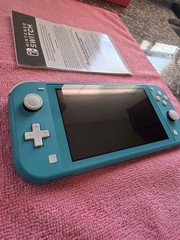 Nintendo Switch Lite Handheld Console – Turquoise With Game And Charger.