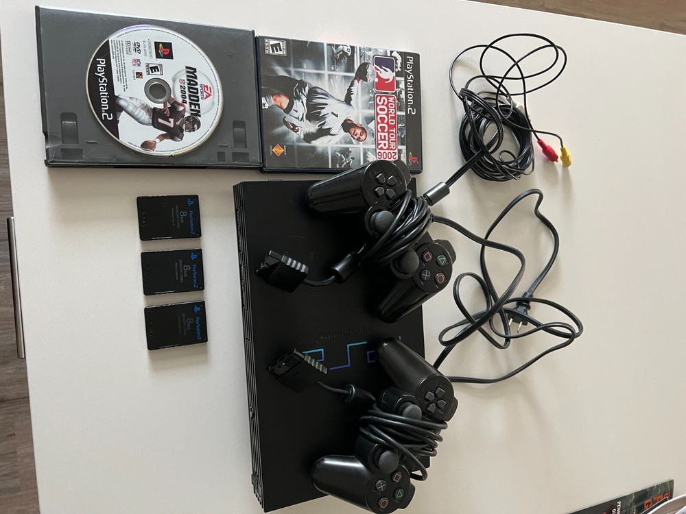 PlayStation 2 console bundle (2 controllers, 2 games, & 3 8mb memory cards)